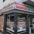 Traditional Commercial Street Storefront With Sandwiches Coffee Candies And Christmas Decorations