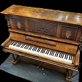 Classic Vintage Wooden Piano With Intricate Carvings And Black White Keys