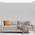 Light Gray Two Seater Sofa Featuring Orange Cushion Gray Fringe Blanket And Black Slim Legs
