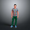 A Man Wearing Colorful Patterned T-Shirt Green Pants And Blue Shoes Against Gray Background