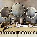 Dressing Table with Three Round Mirrors Three Globe Lights Light Blue Chair and Cosmetic Bottles