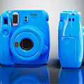 Blue Polaroid Instant Camera Front And Side View Digital Photography Device