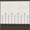 Nine Black Candle Lamps Neatly Arranged In Room With Light Colored Wall And Wooden Floor