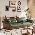 Green Leather Two Seater Sofa with Framed Artworks Floor Lamp Potted Plant and Coffee Table