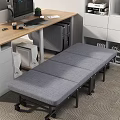 Comfortable Gray Foldable Sofa Bed In Modern Office Workspace Near Desk And Cabinets