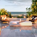 Outdoor Patio Garden With Ocean View Fire Pit Comfortable Chairs And Lush Trees