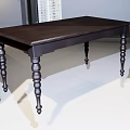 Dark Wooden Dining Table With Decorative Turned Legs In Bright Room With Natural Light