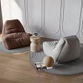 Brown and Beige Bean Bag Chairs on Knitted Rugs with Side Table and Decorative Ball