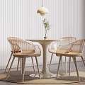 Modern Round Negotiation Table With Four Light Colored Chairs Hanging Lamp And Green Plant
