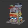 Two Story Small Shop Building With Blue Yellow Exterior Red Signage Striped Awning And Roof Plants