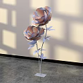 Decorative Floral Installation With Large Flowers Metallic Stems Leaves White Base Light Shadow Background