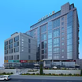 Modern Multi Story Office Building With Front Steps Greenery And Parking Area