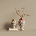 Two Colorful Polka Dot Ceramic Vases With Dried Branches On Books Against Beige Wall