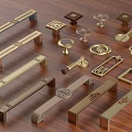 Stylish Metal Cabinet And Drawer Handles With Diverse Designs On Wooden Surface