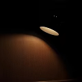 Modern Wall Lamp With Conical Shade Mounted On Dark Wooden Wall Soft Lighting