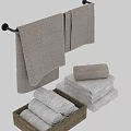 Beige and White Textured Cotton Towels Stacked and Rolled in Woven Basket