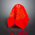 Red Decorative Covering With Golden Mesh Texture And Shiny Surface On Gray Background