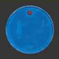Standing Blue Barrel With Yellow Essential Label On Dark Reflective Surface