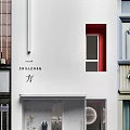 CHILLCHAN Modern Storefront Design With White Facade Red Accent And Square Element