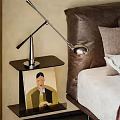 Modern Bedside Table With Sleek Table Lamp Artwork And Bed In Bedroom