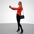 Woman Taking Selfie In Red Long Sleeve Top With Dark Pants Black Boots And Handbag