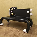 Cute Cartoon Cat Shaped Public Chair With Black Body Yellow Eyes And White Paws