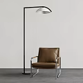 Modern Floor Lamp With Brown Leather Chair Against White Wall And Gray Floor