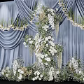 Bridal Photo Check In Spot With Blue Curtain White Flowers And Greenery Decorations