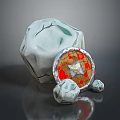 Decorative Grey Stone Object With Round Shield Featuring Red And Yellow Pattern And Small Stones