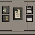 Modern Artworks Hanging on Light Colored Wall With Black Frames and Central Larger Piece