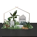 Welcome House Model and Logo in Wooden Frame with Green Plants and Woven Baskets