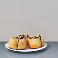 Fresh Baked Donuts With Chocolate Drizzle On White Plate Gray Tabletop