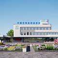Modern Office Building Exterior With Large Windows Landscaped Garden And Colorful Flower Beds