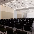 Spacious Modern Conference Room With Neatly Arranged Black Chairs And Large Projection Screen