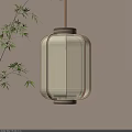 Modern Square Lantern With Glass Warm Yellow Light Hanging By Bamboo Leaves Against Beige Wall