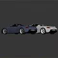 Two Silver And Blue Convertible Sports Cars With Sleek Design And Glossy Finish