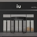 Modern Hotel Entrance With Revolving Glass Door And Black Facade IU Signage