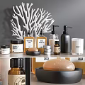Stylish Bathroom Accessories Collection With Soap Bottles Plant Candle And Coral Decor