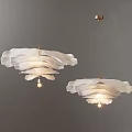 Modern White Layered Chandeliers With Golden Brackets Illuminated On Gray Wall