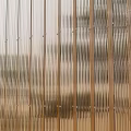 Transparent Gradient Partition With Vertical Stripes Orange Shade And Background Plants On Wooden Floor
