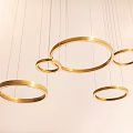 Golden Circular Chandelier with Multiple Hanging Rings in Modern Interior Space