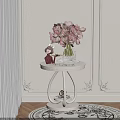 White Side Table with Pink Flowers in Vase and Decorative Figurine Against Decorative Wall