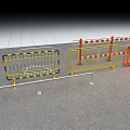 Various Construction Barriers With Yellow Orange And Striped Designs On Gravel Ground