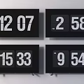 Black Televisions Showing Four Different Digital Time Displays On Screens