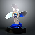 Artistic Propeller Shaped Sculpture With Three Blades Central Emblem Blue Wave Base And Black Pedestal