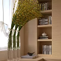 Yellow Flowers in Clear Vase with Bookshelf and Beige Interior Wall