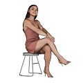 Woman In Brown Dress Sitting On White Stool With Crossed Legs And White Background