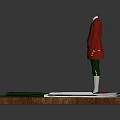 Mannequin In Red Coat And Green Pants With Fabric Pieces And Ruler On Wooden Table