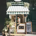 Charming Specialty Store With Green And White Striped Awning Menu Blackboard And Plants
