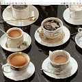 White Porcelain Coffee Cups With Gold Trim And Saucers On Black Tabletop Featuring Latte Art